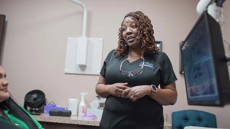 Nesha giving a patient information on dental veneers at Tulsa Premier Dentistry