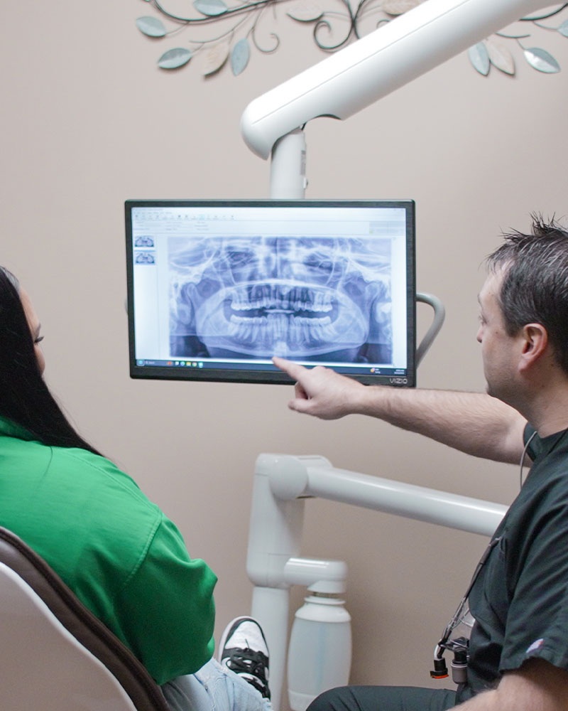 Dr. Coursey showing X-rays for dental implants
