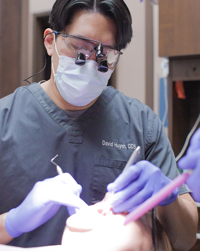 Dr. Huynh providing dental care for a patient